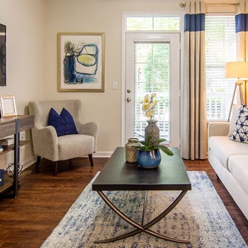 a living room with a couch, tables and a tv