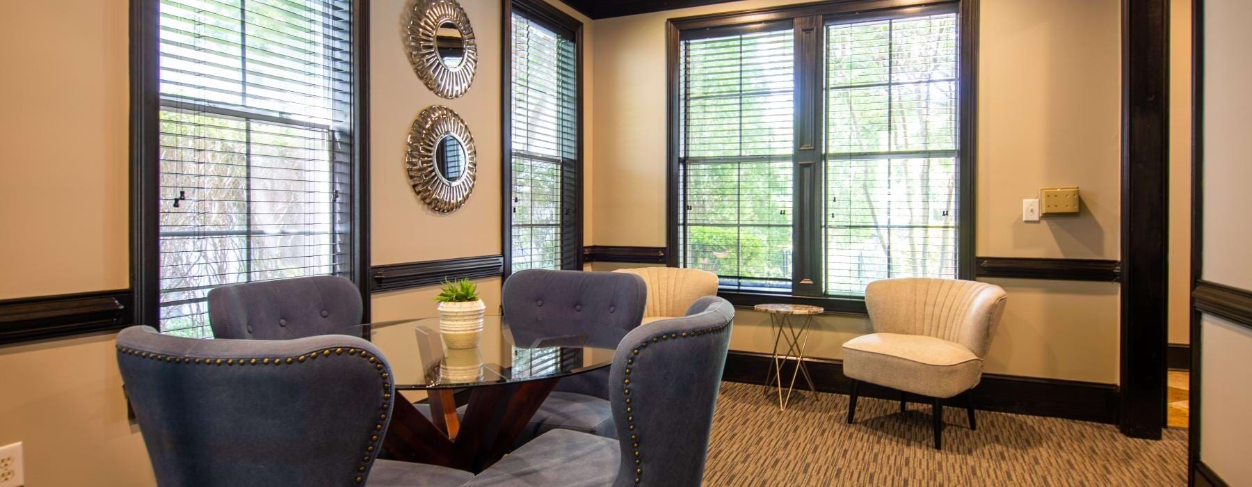 a room with a table chairs and a mirror
