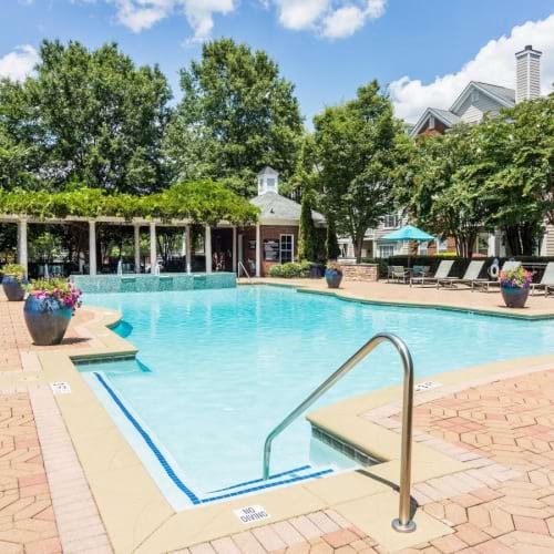 a swimming pool with a building in the background